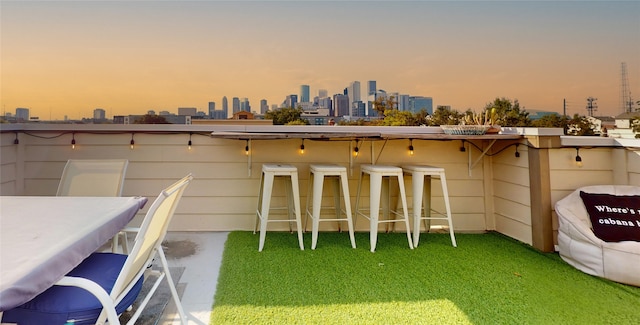 patio terrace at dusk with a bar and a yard