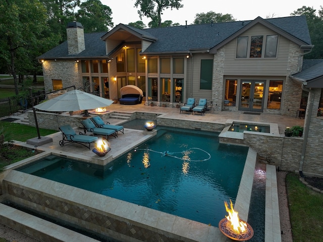 view of swimming pool featuring an in ground hot tub, a patio area, and a fire pit