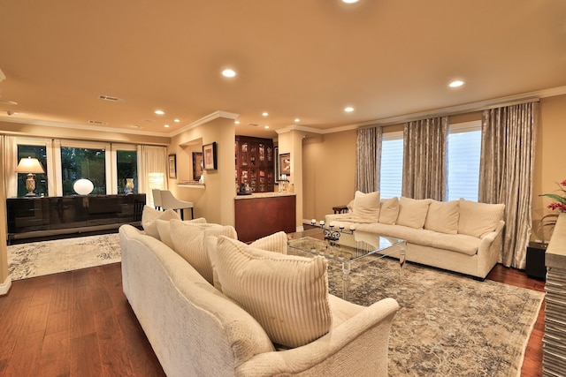 living room featuring ornamental molding and dark hardwood / wood-style flooring