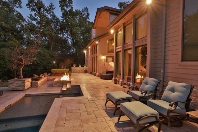 view of patio / terrace featuring an outdoor fire pit