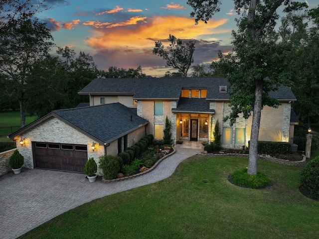 view of front facade with a garage and a yard