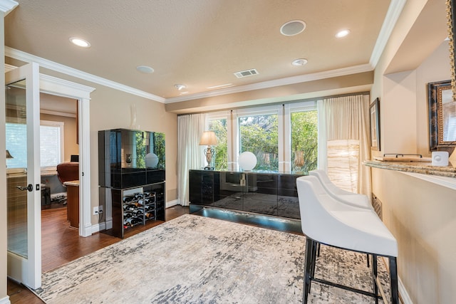 office area with a textured ceiling, crown molding, and dark hardwood / wood-style flooring