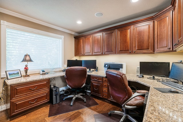 office with built in desk, crown molding, a textured ceiling, and dark hardwood / wood-style flooring