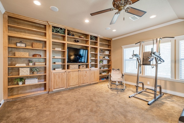 workout area with ceiling fan, vaulted ceiling, crown molding, and carpet flooring