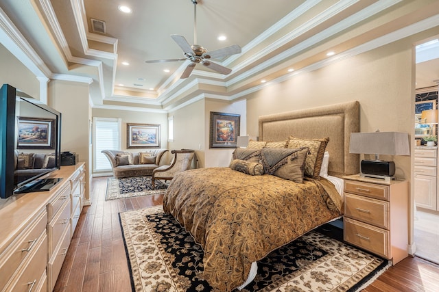 bedroom featuring ceiling fan, a raised ceiling, crown molding, and dark hardwood / wood-style floors