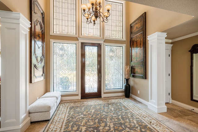 foyer entrance featuring a notable chandelier and crown molding