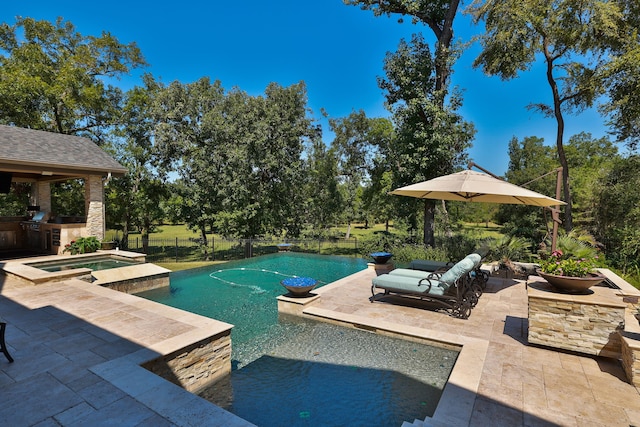 view of swimming pool with a patio and an in ground hot tub