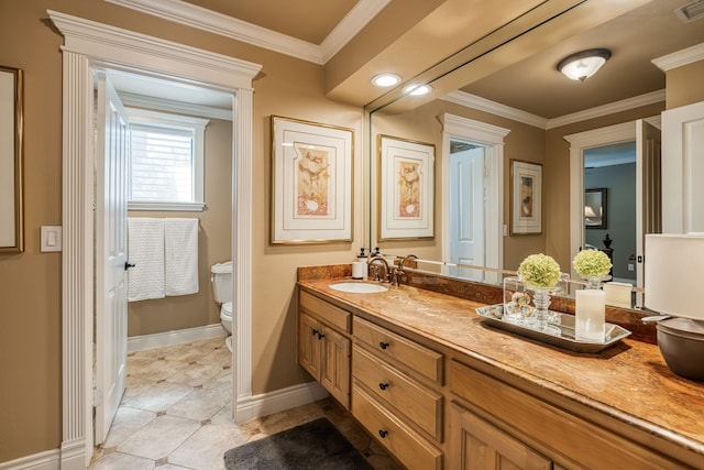 bathroom with ornamental molding, vanity, and toilet