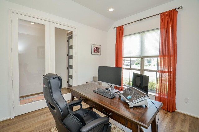 office featuring light hardwood / wood-style floors and lofted ceiling