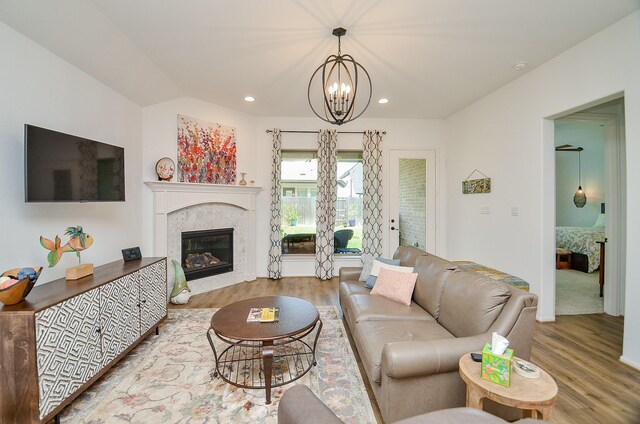 living room with hardwood / wood-style floors and a notable chandelier