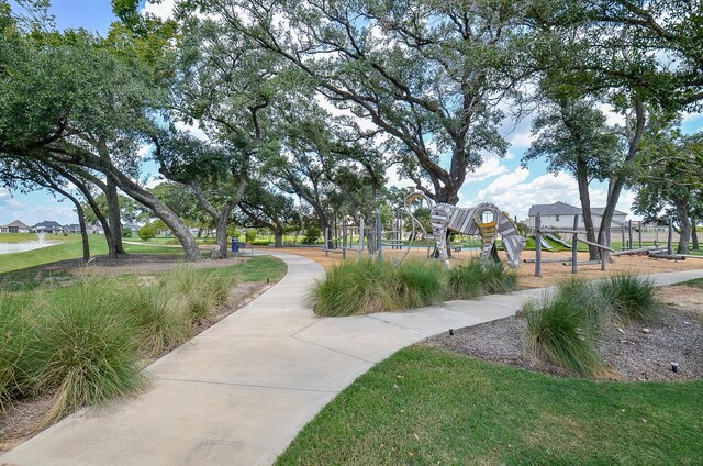 view of home's community with a lawn and a playground