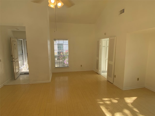 spare room featuring ceiling fan, light hardwood / wood-style floors, and high vaulted ceiling