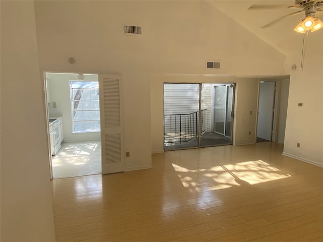 unfurnished room with high vaulted ceiling, light wood-type flooring, and ceiling fan