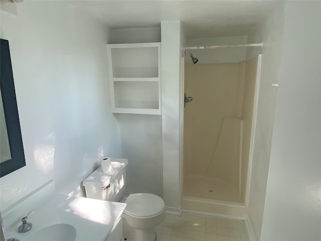 bathroom with walk in shower, vanity, tile patterned flooring, and toilet