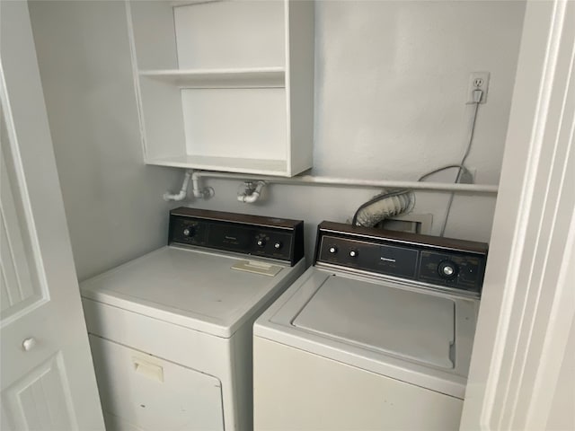 clothes washing area featuring independent washer and dryer