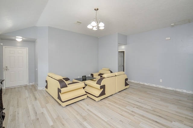 living room featuring light hardwood / wood-style floors, vaulted ceiling, and a chandelier