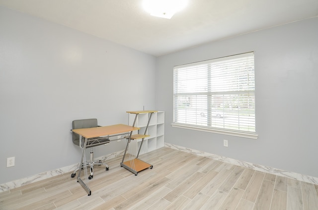 office with light wood-type flooring