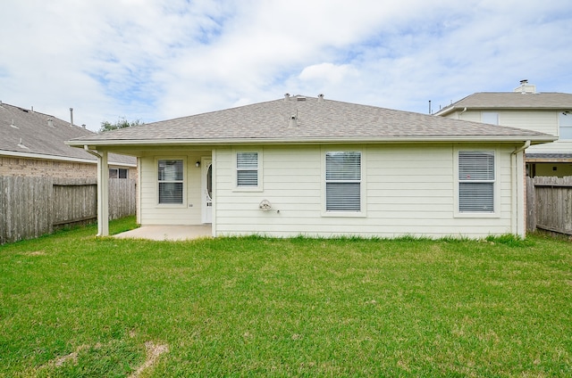 rear view of house with a yard