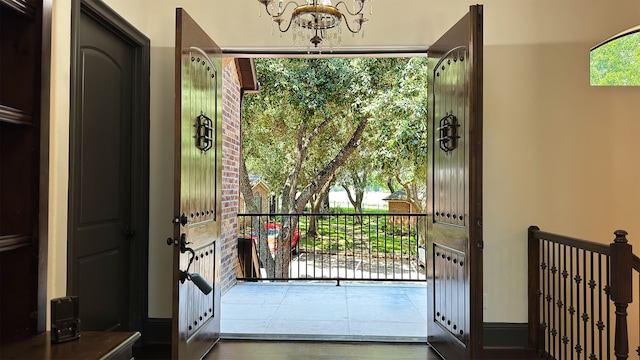 doorway featuring a notable chandelier