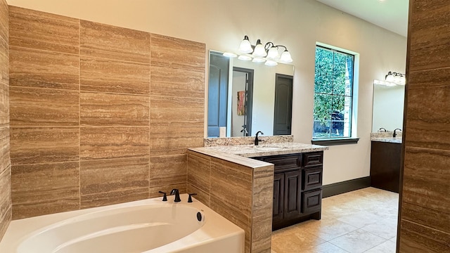 bathroom featuring a bathing tub, tile patterned flooring, and vanity