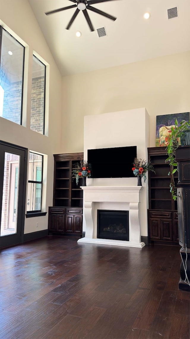 living room with lofted ceiling, ceiling fan, and dark wood-type flooring