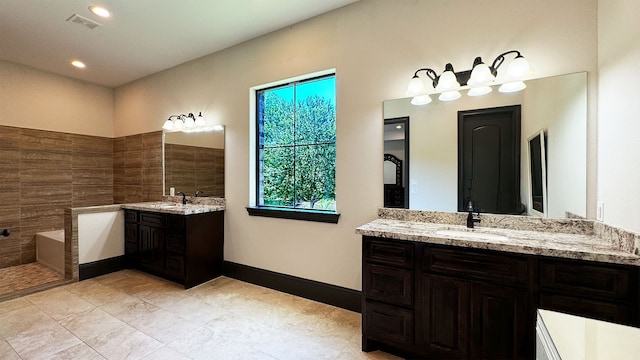 bathroom with tile patterned flooring, vanity, and tile walls