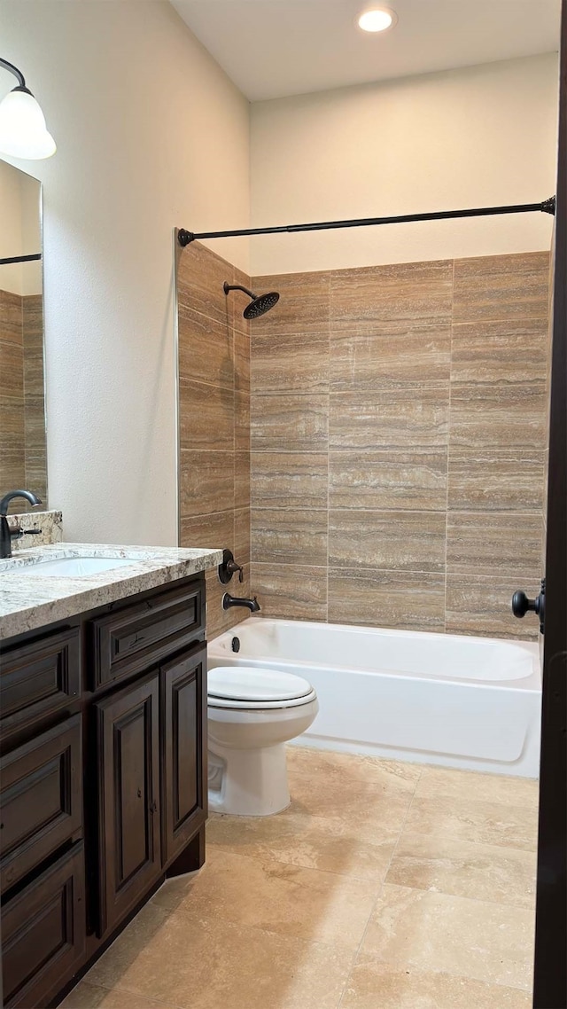 full bathroom with vanity, toilet, and tiled shower / bath