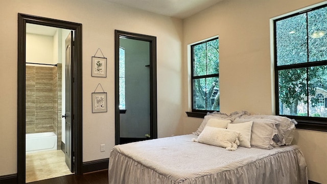 bedroom featuring hardwood / wood-style floors and connected bathroom