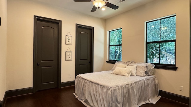 bedroom featuring ceiling fan and dark wood-type flooring