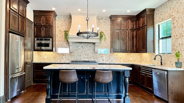 kitchen featuring decorative backsplash, dark hardwood / wood-style flooring, a kitchen island, and appliances with stainless steel finishes