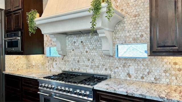 kitchen featuring backsplash, stainless steel appliances, and a wealth of natural light