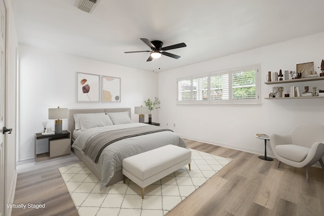 bedroom with ceiling fan and light hardwood / wood-style floors