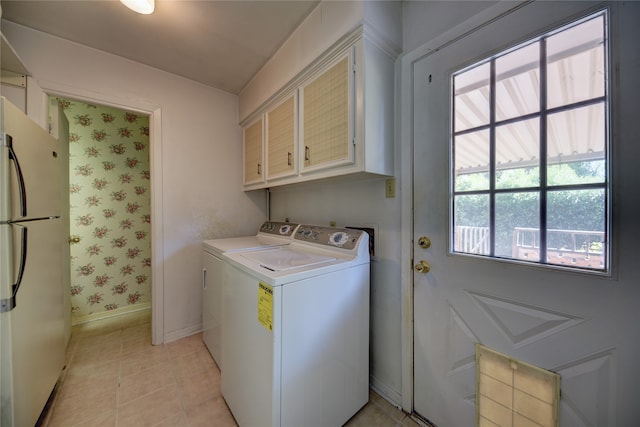 laundry room featuring light tile patterned flooring, cabinets, and independent washer and dryer