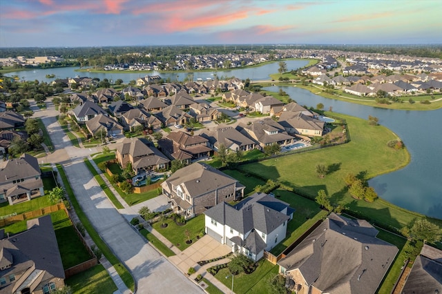 aerial view at dusk with a water view