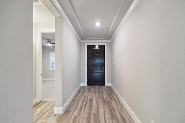 doorway to outside with light hardwood / wood-style flooring and crown molding