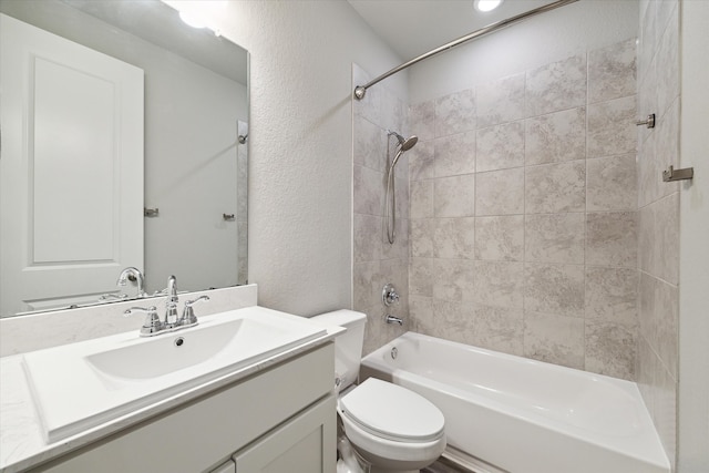 full bathroom featuring vanity, toilet, and tiled shower / bath