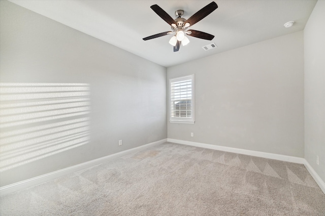 carpeted empty room featuring ceiling fan