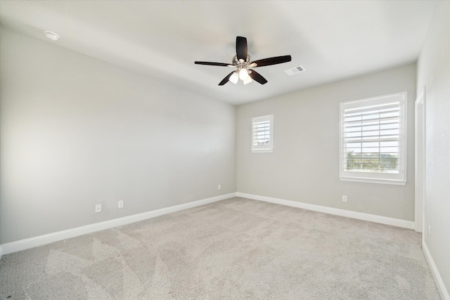 carpeted spare room with ceiling fan