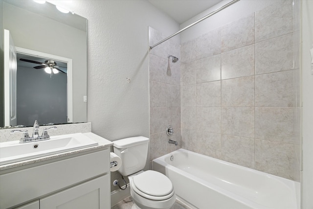 full bathroom featuring toilet, tiled shower / bath combo, vanity, and ceiling fan