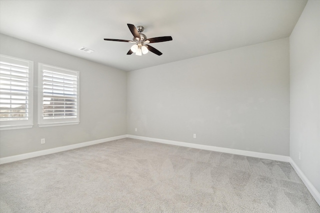 carpeted empty room featuring ceiling fan