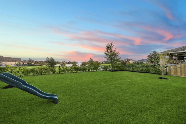 view of yard at dusk