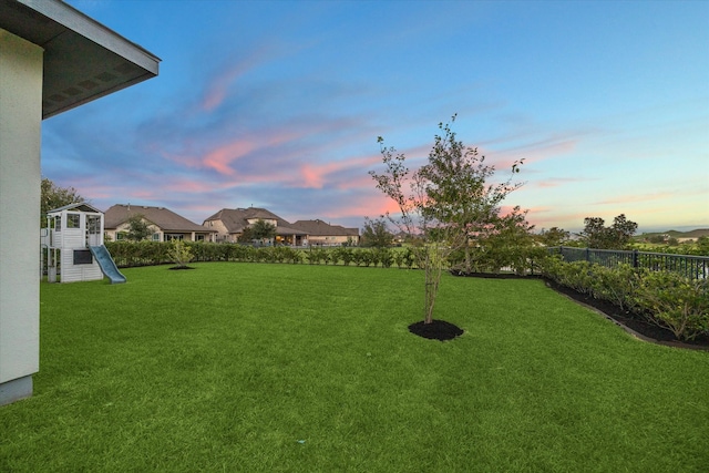 view of yard at dusk