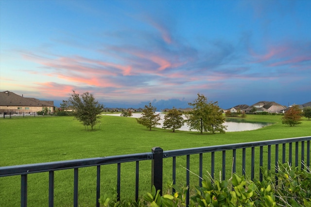 yard at dusk with a water view