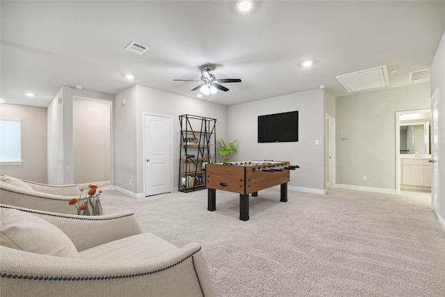 game room with ceiling fan and light carpet