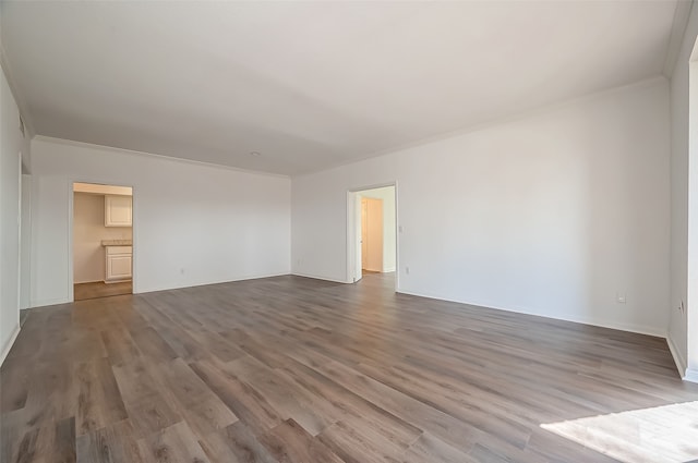 empty room with light hardwood / wood-style flooring and crown molding