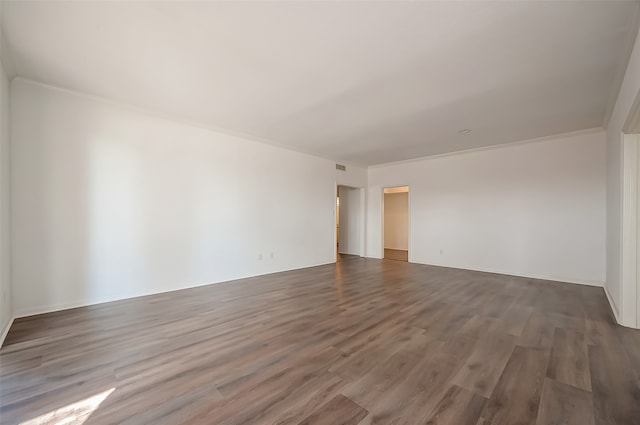 unfurnished room with dark hardwood / wood-style floors and ornamental molding