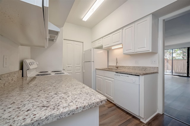kitchen with dark wood-type flooring, white cabinetry, a sink, and white appliances