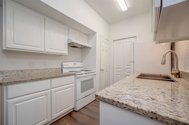 kitchen with white range with electric stovetop, wood finished floors, a sink, white cabinetry, and under cabinet range hood