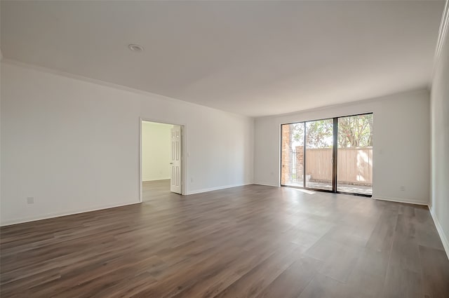 empty room featuring ornamental molding and dark hardwood / wood-style floors