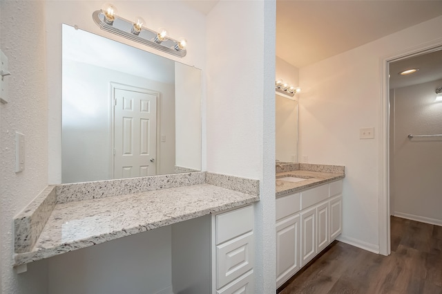 bathroom featuring vanity and hardwood / wood-style floors